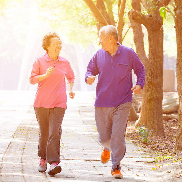Senior couple brisk walking outdoors